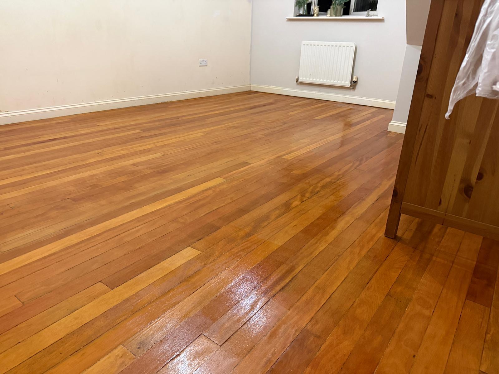 Hardwood Floor Sanding in eastbarnet on an oak strip hardwood living room floor, fully restored with a smooth, glossy finish.