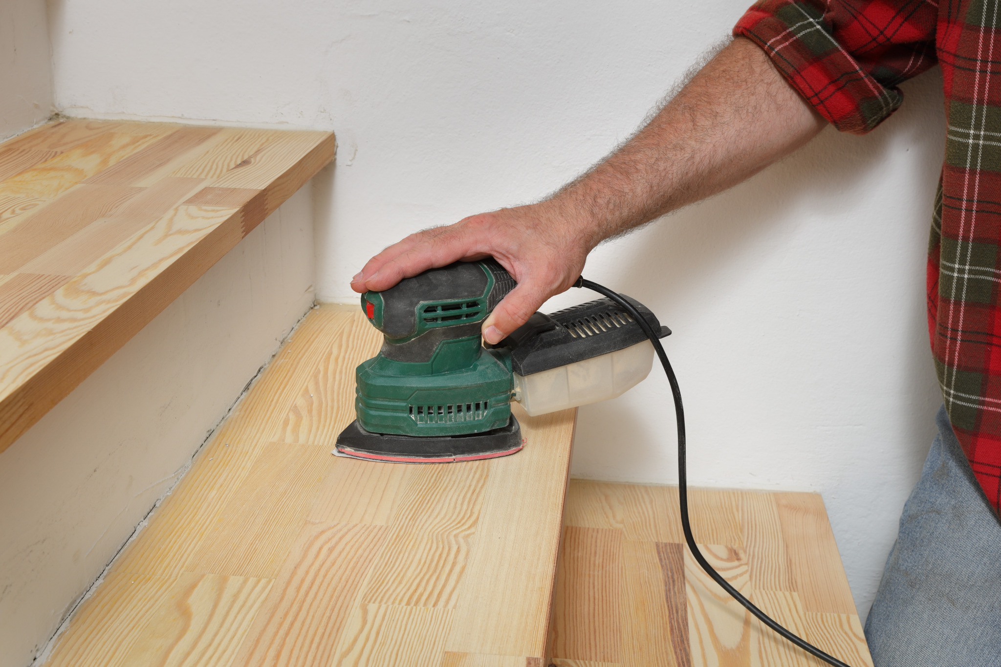 Hardwood Floor Sanding in eastbarnet on pine softwood stair treads, with a professional sander smoothing the steps for refinishing.